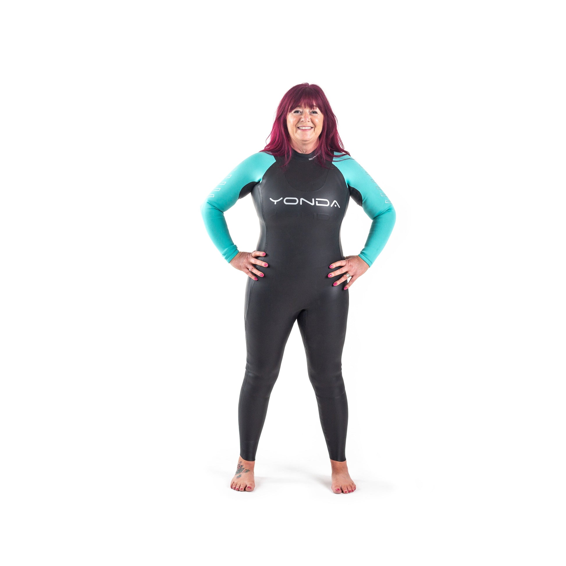Front view of a women in a Spook Wetsuit by Yonda. A beginners Wild Swimming Wetsuit. It is black with aqua arms.