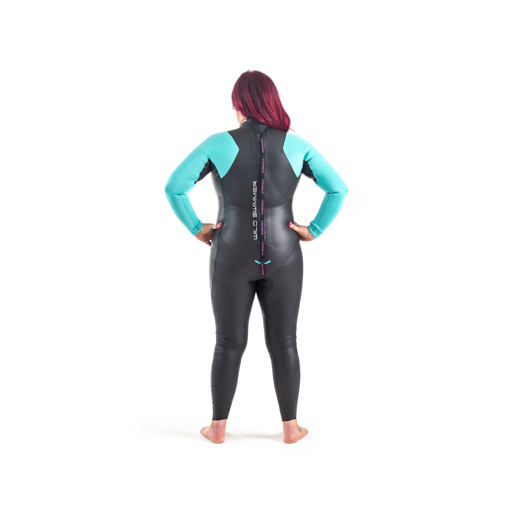 Back view of a women in a Spook Wetsuit by Yonda. A beginners Wild Swimming Wetsuit. It is black with aqua arms.