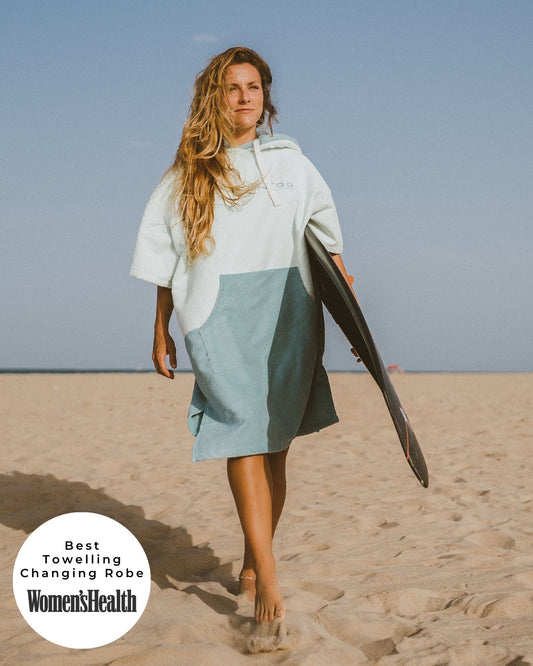 Lead_women Woman wears a Vivida Original Adult Poncho Towel Changing Robe - Seafoam Green. Sticker reads Women's Health's Best Towelling Changing Robe