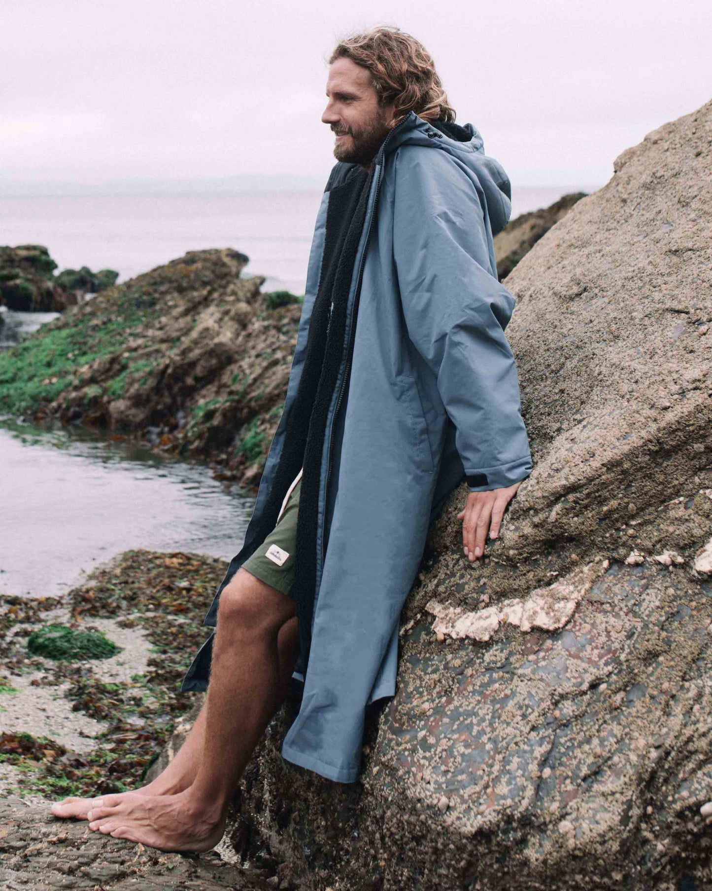 Lead_men - Man wearing the All Weather Sherpa Changing Robe - Mineral Blue