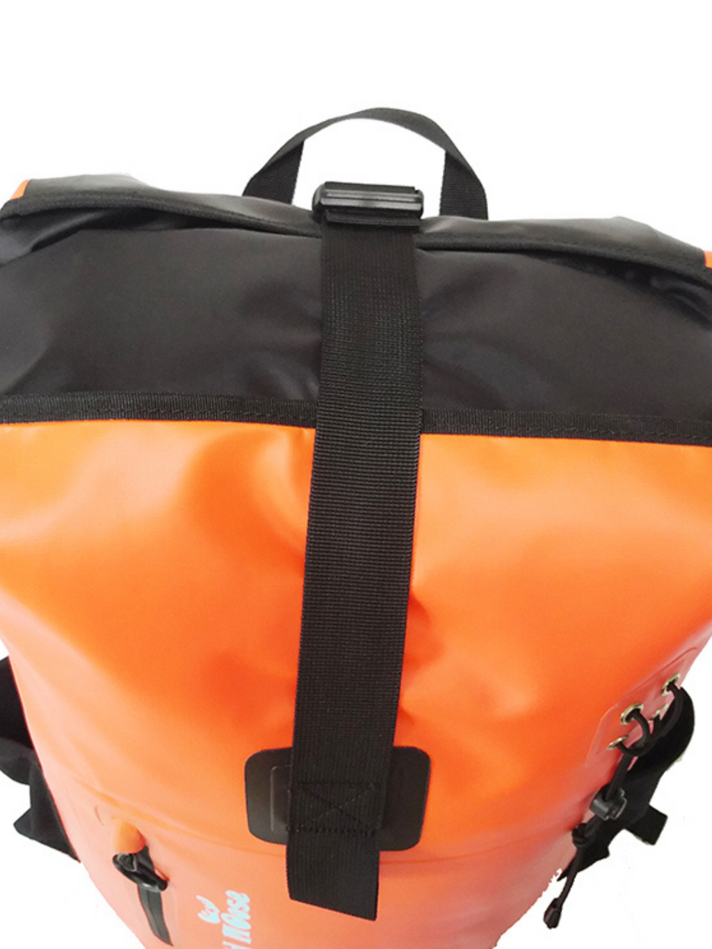 Bright orange waterproof swim backpack beside lake, ideal for carrying kit during wild swimming
