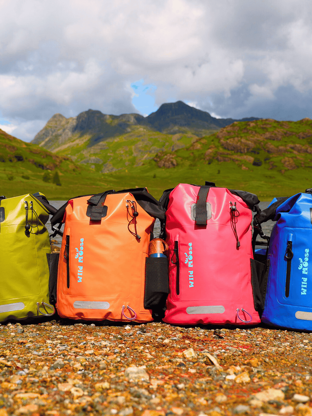 Waterproof 45 Litre Backpacks by some mountains, blue, pink, orange and green colours. Ideal for hiking 