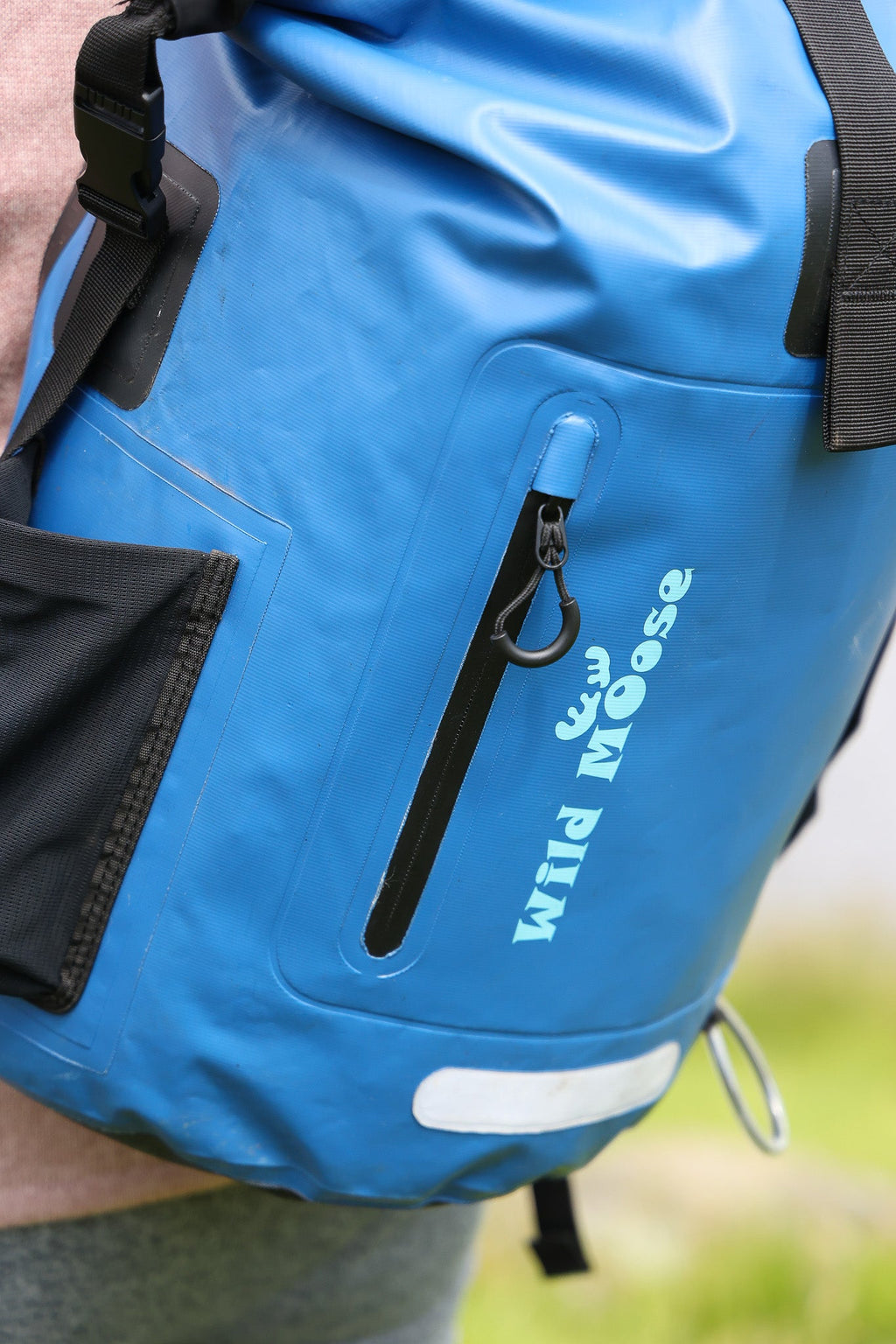 Close-up shot of a blue waterproof 45L backpack by Wild Moose, designed for wild swimmers, cold water swimmers, and open water adventurers.
