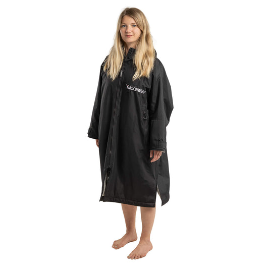 Full length photo of a Woman in the Black Frostfire Moonwrap Waterproof Changing Robe for Wild Swimmers
