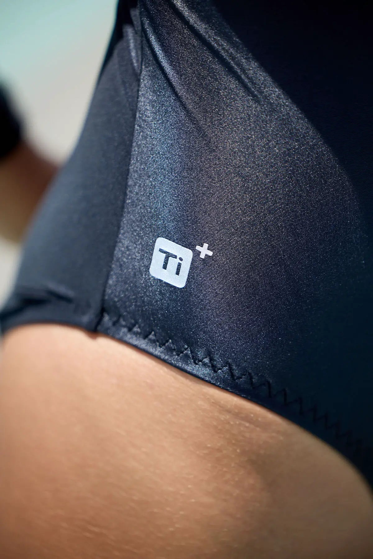 Close up showing titanium - Zone3 Women’s OWS Ti+ Long Sleeve Thermal high neck swimsuit