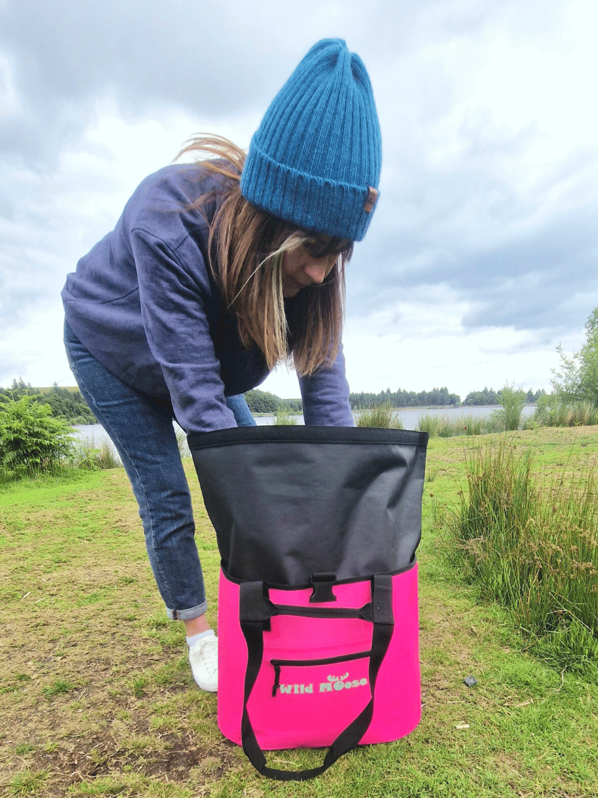 A Wild Swimmer Looking in her Big Waterproof Swim Gear Bag for her Swim Kit.