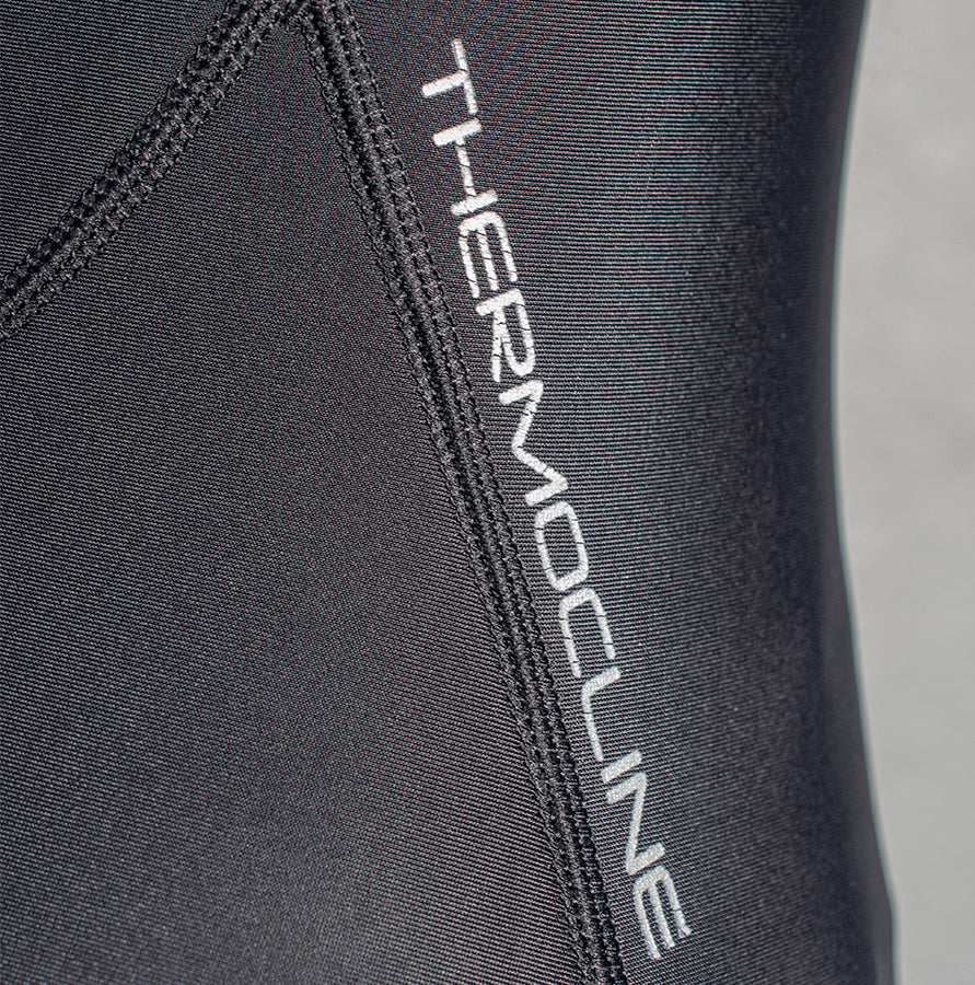 A close up of the word Thermocline on the A woman wearing the Fourth Element - Women’s Thermocline Long Sleeve Swimsuit for Wild Swimming
