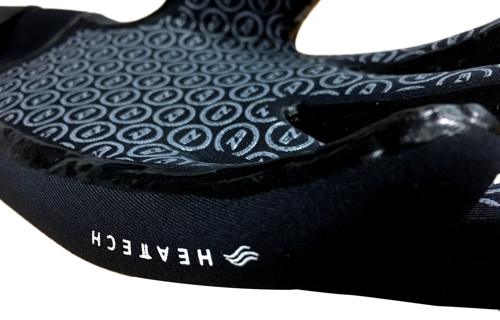 Close up shot of the palm of the Zone 3 Heat Tech Warmth Neoprene Gloves for Cold Water Swimming. The Heat Tech writing on the glove is showing.